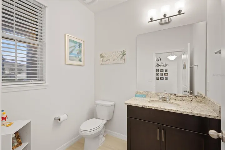 First flr half bath with granite countertops and espresso vanity.