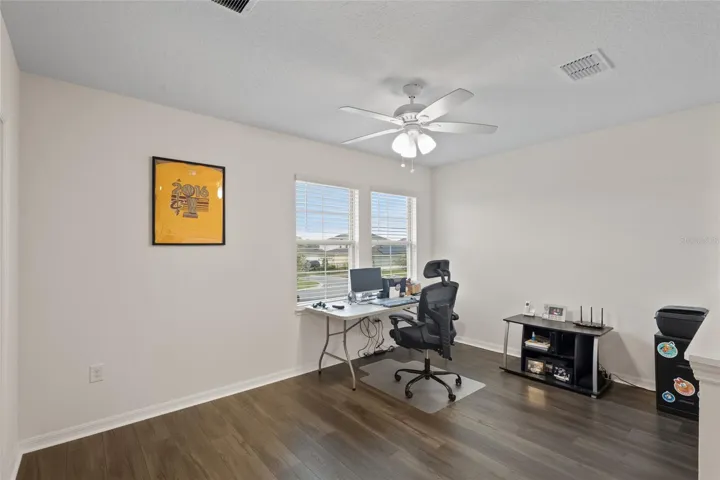 Great loft area with laminate and ceiling fan!