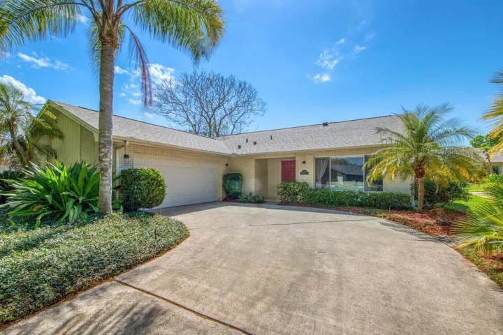 Mature landscaping & wide driveway with side-opening garage~