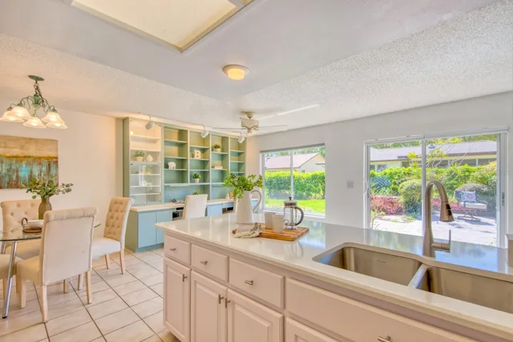 Casual dining area, flex space & family room open to back yard patio~