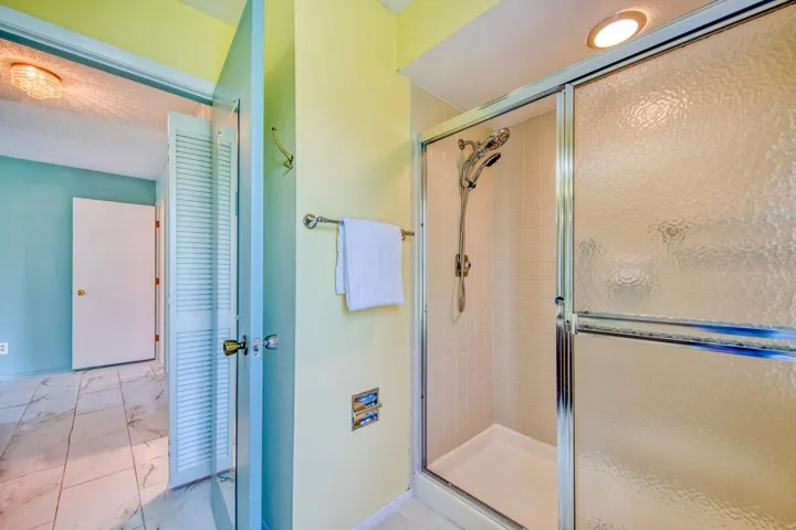 Step in tile shower with dual shower heads & glass doors~