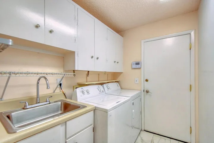 Laundry room w/cabinets, sink & access to garage~
