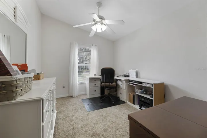Den/Office features an Arched Window & Ceiling Fan