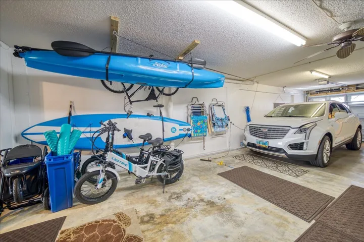Garage with tandem parking and extra storage space.
