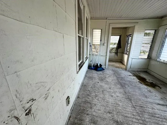 UPSTAIRS APT - Front enclosed porch  - floor needs repair and refinishing