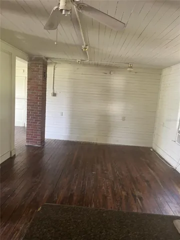 DOWNSTAIRS APT - Living room off of kitchen - bedroom is to the left of brick column