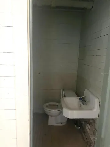 DOWNSTAIRS OFFICE AREA - half bath in front section office space