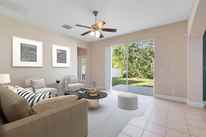 This photo has been virtually staged. Sliding glass doors in the family room open up to a wonderful patio space.