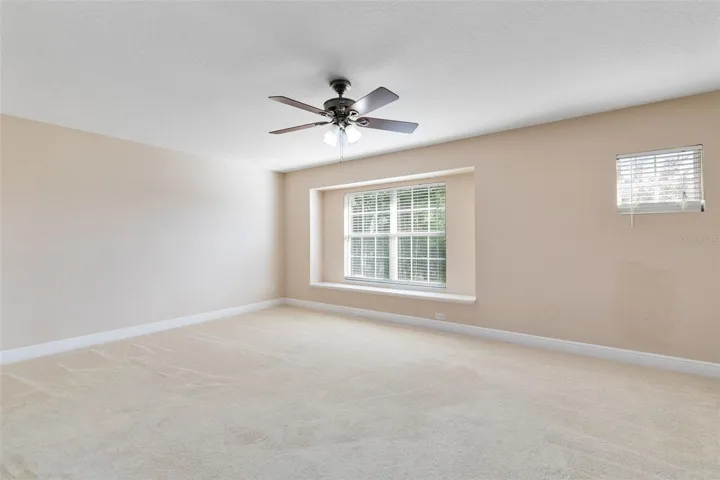 The spacious master bedroom features a cozy window seat