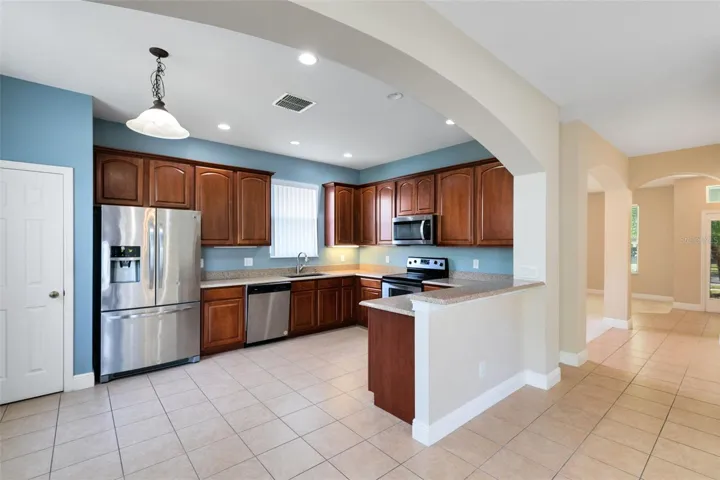 The eat-in kitchen features granite counters and stainless steel appliances.