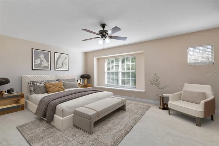 This photo has been virtually staged. The spacious master bedroom features a cozy window seat.