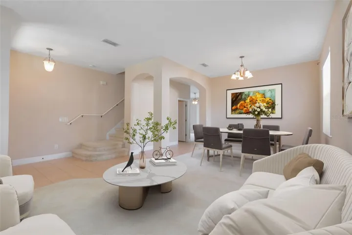 This photo has been virtually staged. A view from the formal living room into the formal dining room.