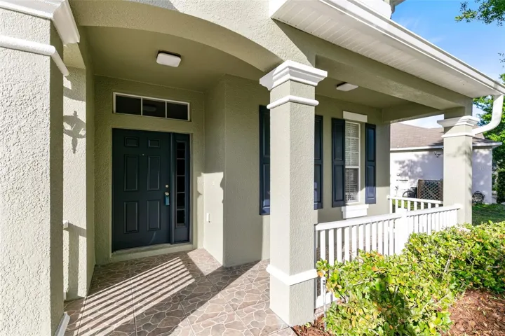 Upon arrival, a quaint covered front porch awaits.
