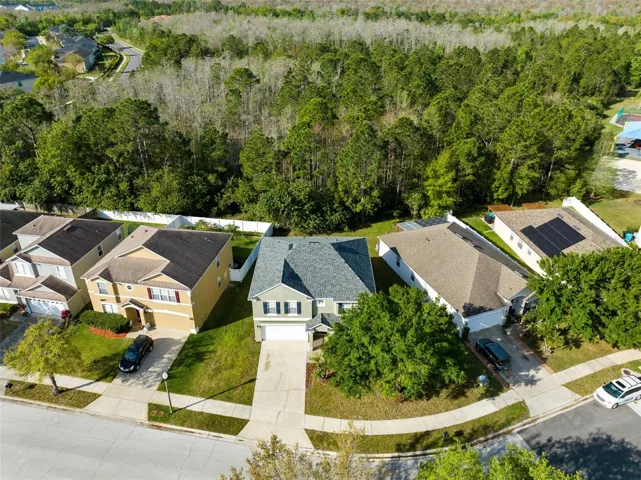 Aerial view of the front of the home with the conservation area to the rear of it.