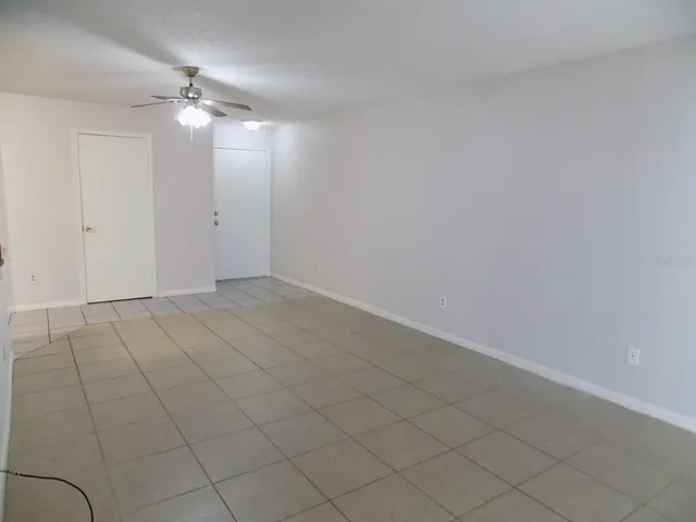 Living room looking toward front door and storage closet
