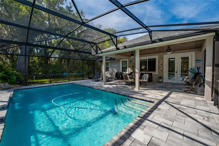 covered and screened-in patio and salt-water pool
