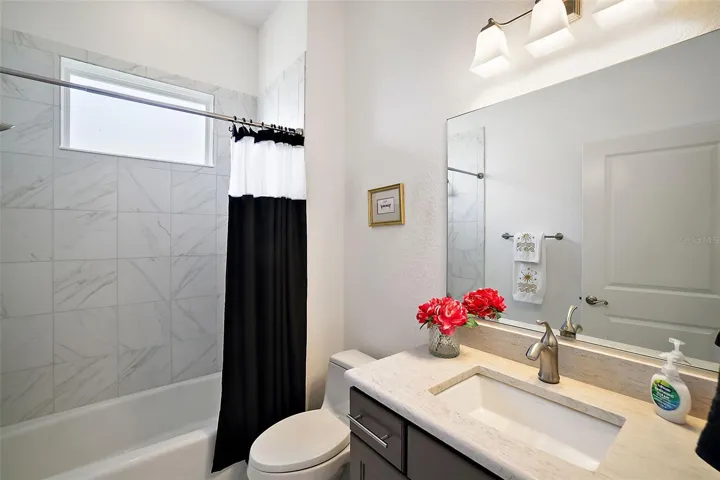 Bathroom 2 with single vanity and tub/shower