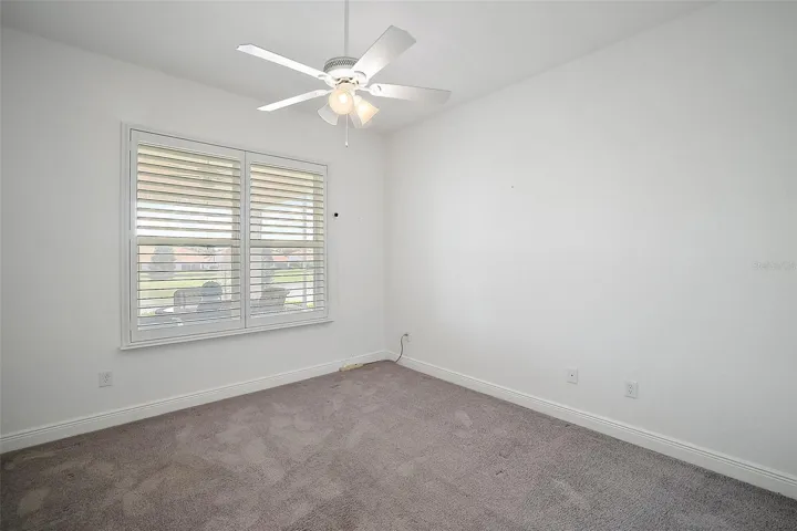 Bedroom 3 with ceiling fan and carpeting