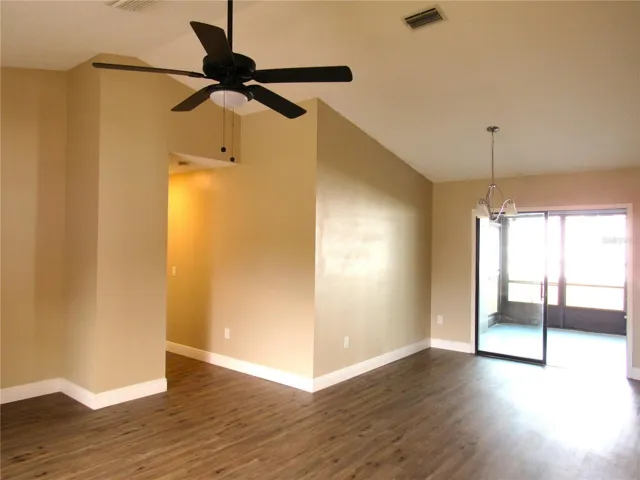 Large Beautiful Great Room With Cathedral Ceiling, Luxury Vinyl Plank Flooring and Glass Sliding Doors To Lanai.
