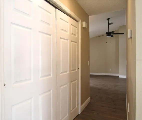 Indoor Laundry Station Closet with Sliding Door + Additional Miscellaneous Storage Closet With Shelving.