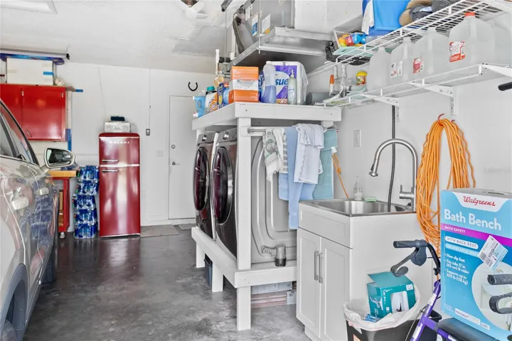 Laundry and utility tub in garage.  all appliances stay