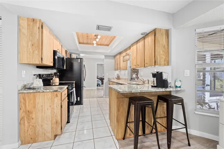 Galley Kitchen with Granite Countertops and Breakfast Bar