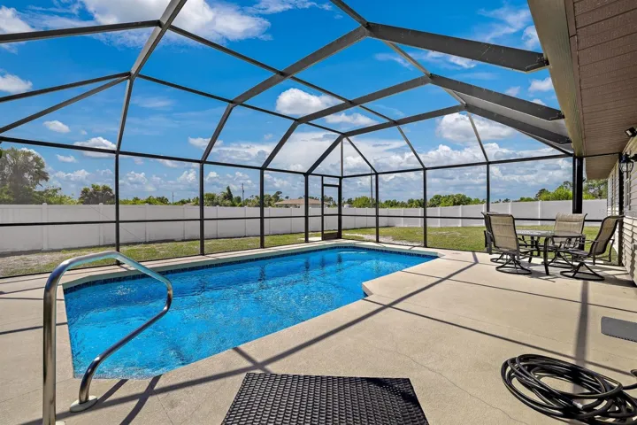 Large heated pool with newer Mansard screen enclosure