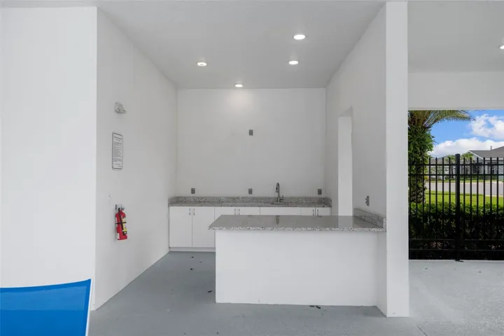 Outdoor kitchen off of community pool area