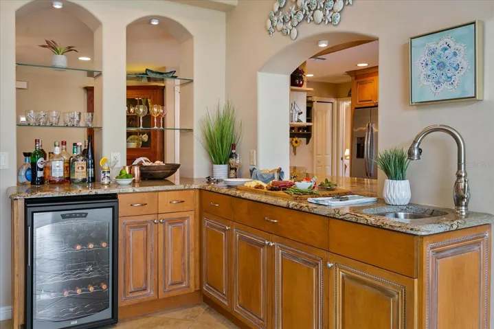 Bar area with wet sink and wine fridge, open out Great Room, Dining Room and Kitchen!