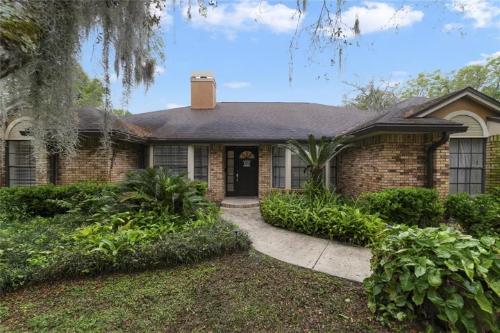 Tucked away among the trees on OVER AN ACRE this beautifully upgraded home features a NEWER ROOF (2017), UPDATED A/C and WATER HEATER, high ceilings, a gorgeous kitchen and a must see primary closet!