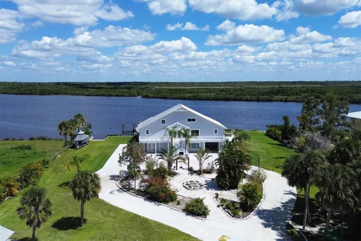 Nestled in the coastal greenery of Venice Florida, stands the Old World charm of this 5,000+ sq ft home on the Myakka River.  Featuring two boat lifts and boat ramp. This Riverfront Gem, is a picture of serenity.