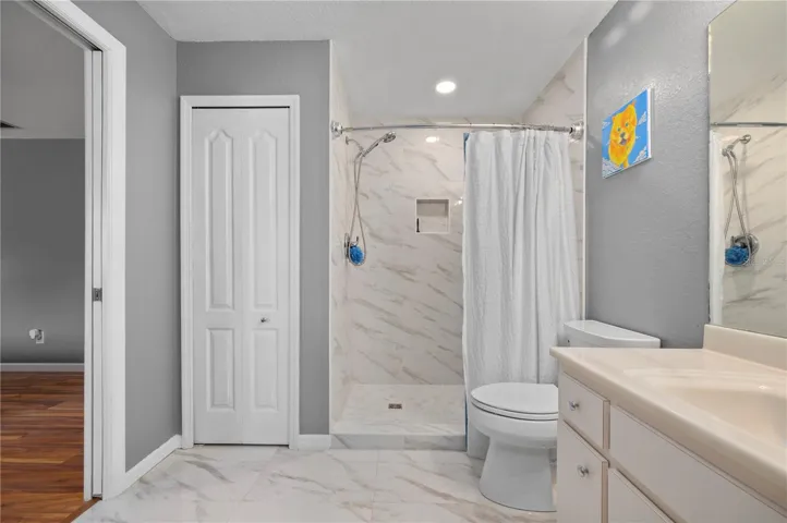 Primary bath.  Renovated shower, new toilet and tile flooring.