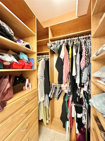 Walk-in closet located in primary bathroom