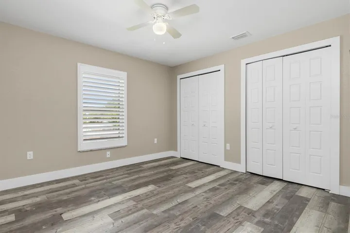 Bedroom on right side has connecting large closet and plantation shutters.