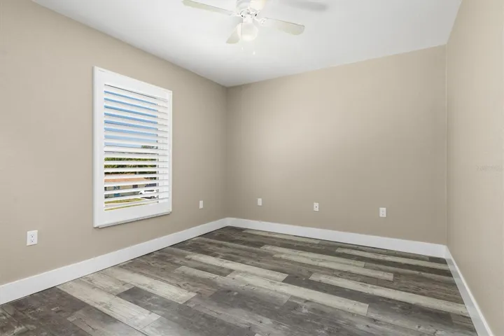 Bedroom on left has a walk-in closet and plantation shutters.