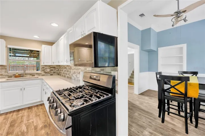 Updated kitchen with modern appliances, quartz, and vinyl plank flooring