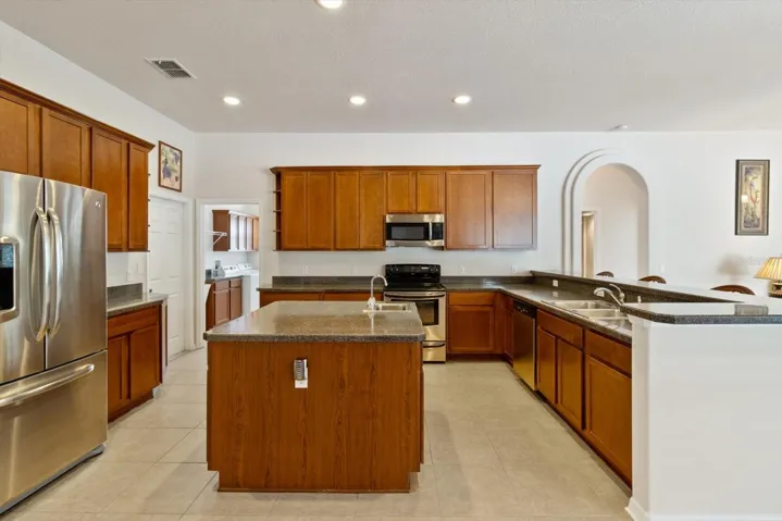 Spacious Kitchen with Stainless Steel Appliances, Plenty of Cabinetry & Countertop Space, Island w/ 2nd Sink, Breakfast Bar & Pantry Closet