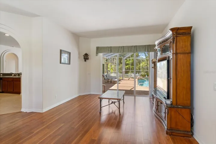 Formal Living Room w/ 3 Panel Stacking Slider that opens to the Lanai w/ Pool