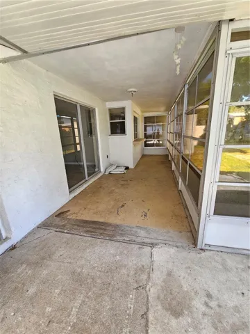 Back Porch from outside Primary Bathroom access door, view left, featuring sliding doors and breakfast bar.