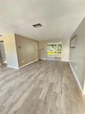 Adjacent Open Living Space with Glass Sliding Doors to Patio
