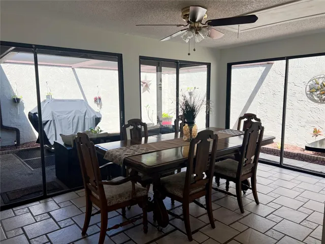 Living Room with 3 Glass Sliders to Patio