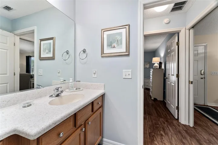 View from BATHROOM #2 shows HALLWAY to BR #2 (L) & POCKET DOOR (R) for guest PRIVACY.