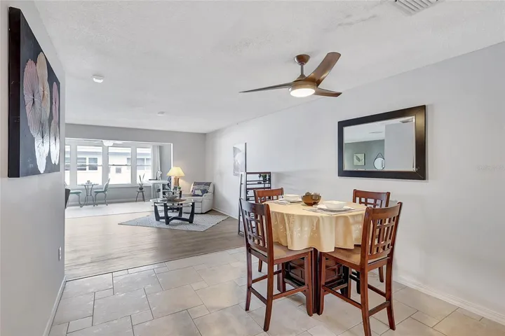 Open dining area with a beautiful ceiling fan with remote