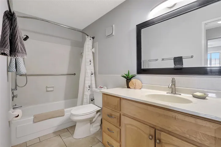 Bathroom has a tub/shower combo.