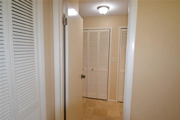 View of hall to largest bedroom.  Wall of closets