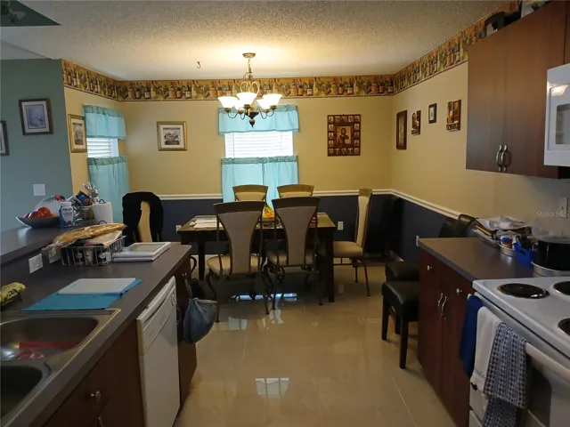 Dining area off the kitchen..Note the gleaming tiled floors..