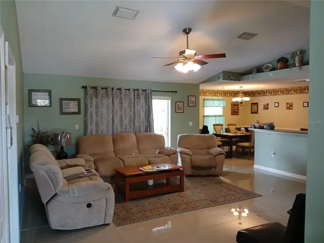 Great Room with large plant shelves and high vaulted ceilings