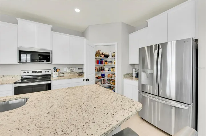 Brand new top-of-the-line LG refrigerator, a luxurious addition to the home's amenities.