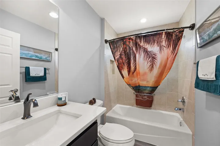 GUEST BATH WITH QUARTZ COUNTERTOPS AND TILE SHOWER