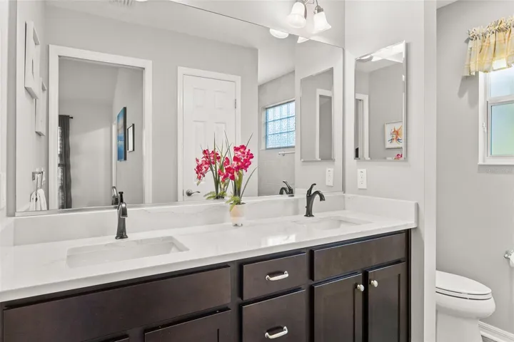 QUARTZ COUNTERTOP DOUBLE VANITY AND ROMAN WALK IN SHOWER